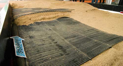 sand covers rubber mat in freestall