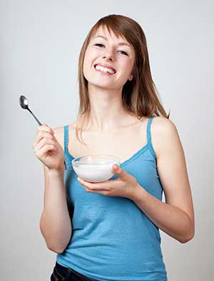 happy woman eating yogurt