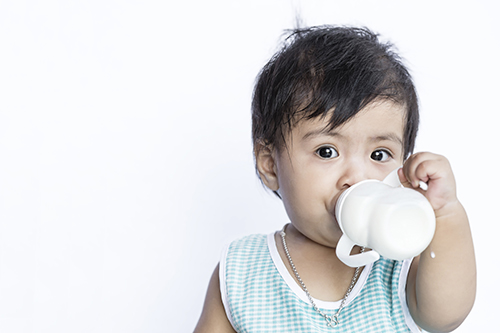 young child drinking milk